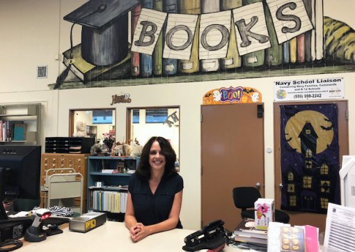 Cathy Zaharris is shown at her regular perch in the Lemoore High School Library where she has been a library technician for 24 years. She will compete for Kings County Employee of the Year.